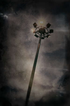 Stadium lights against dark night sky background