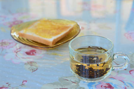 Morning tea with bread on the table.の写真素材