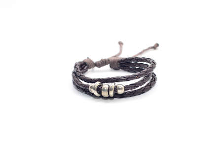 closeup men's leather bracelet on white backgroundの写真素材