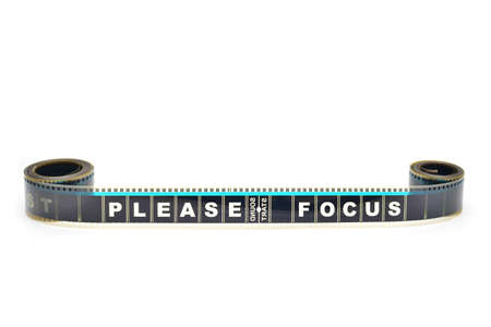 Piece of 35 mm motion film with the word 'please focus' on itの写真素材