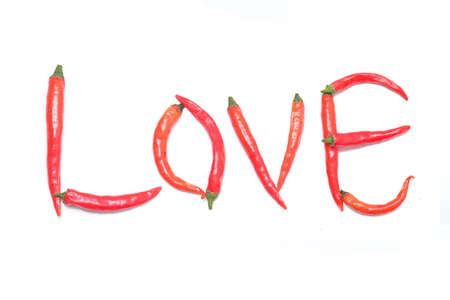 The word love built of red chili peppers on a white background. Isolatedの写真素材