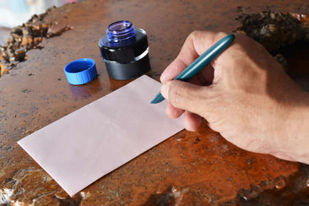 Close up of hand writing address on the letter