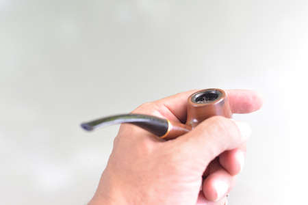 The man holding tobacco pipeの写真素材