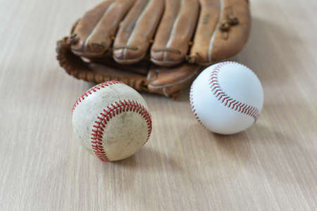 Baseball game. Baseball ball on wooden background. Vintage retro picture.