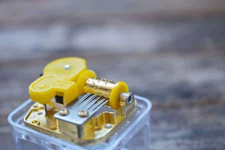 close-up of music box tines isolated on wooden backgroundの写真素材