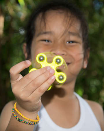 Young boy play with fidget spinner stress relieving toyの写真素材