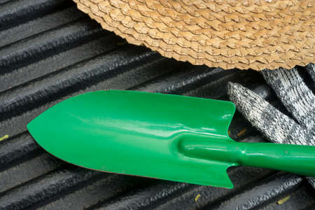 Image of gardening hat with shovel and glovesの写真素材