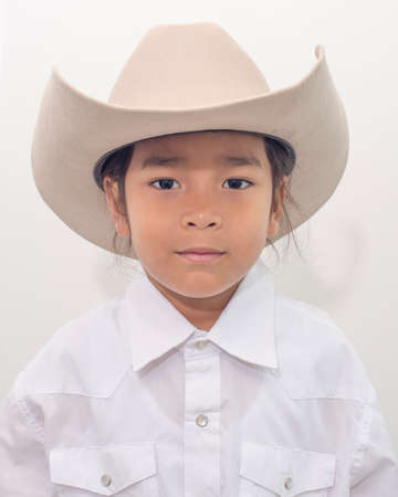 young boy wear cowboy hat isolate on white background.の写真素材