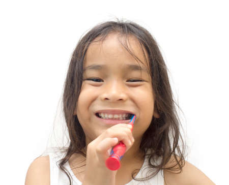Smiling child kid brushing teeth in bathroomの写真素材