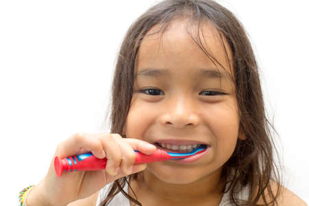 Smiling child kid brushing teeth in bathroom