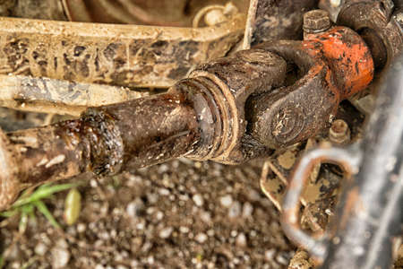 metal steel drive shaft a large size ball bearing support and universal joint with dirty greaseの写真素材