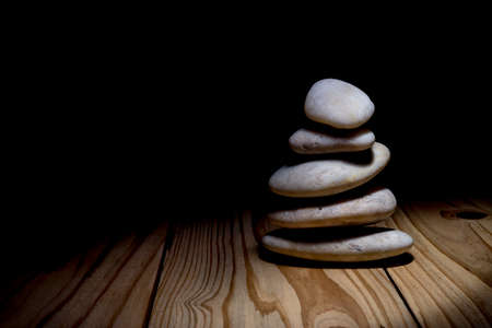 Stack of zen stones on wooden backgroundの写真素材