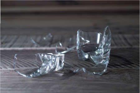 Broken glass on wooden background.