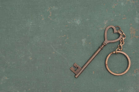 Heart key on a rough green backgroundの写真素材