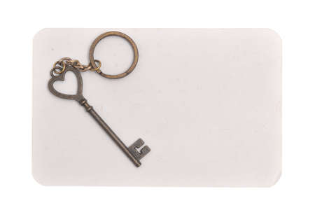 Heart key on gray paper a white background の写真素材