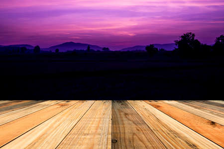 wood terrace with sunrise and sunset sky background.の写真素材