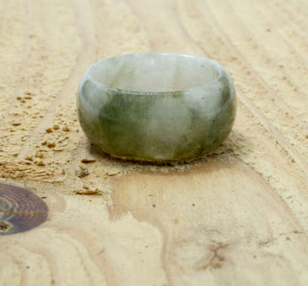 Jade ring on wooden backgroundの写真素材