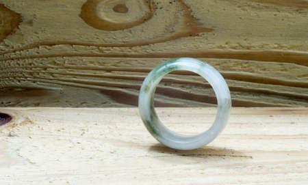Jade ring on wooden backgroundの写真素材