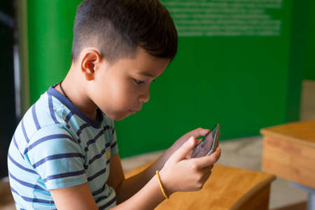 Child looking at the screen, playing games, using apps. people, technology, leisure concept