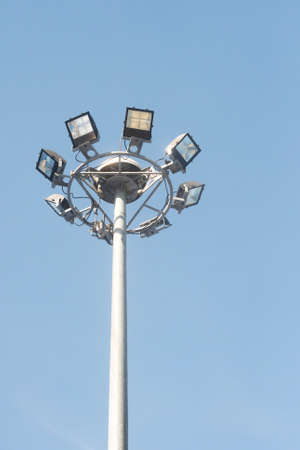 Stadium light pole with blue sky on bright day