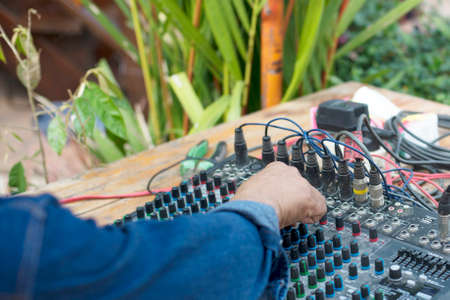 Hands of male and sound mixer