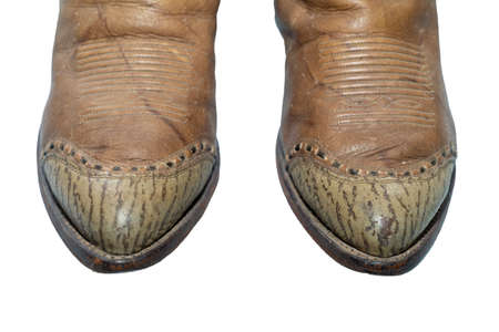 Brown cowboy boots isolated on a white background.