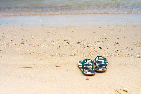 Flip Flops on a sandy ocean beach , Summer vacation concept.