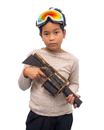 Asian boy holding a gun made of Corrugated Cardboard.Corrugated Cardboard can be reused as a toy...
