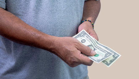 Man counting dollars in hands to pay, close upの写真素材