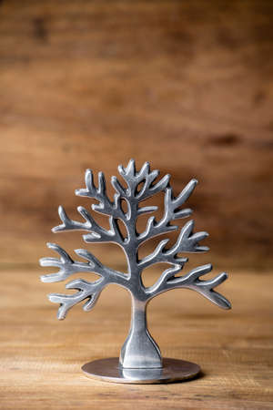 Tree graphic made of steel on the wooden background.の写真素材