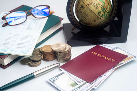 Red passport with banknotes and coins  globe. Travel concept.