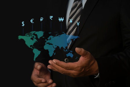 Businessman hand holding world with virtual line effect and dollar yuan yen euro and pound sterling sign. Global currency exchange conceptの写真素材