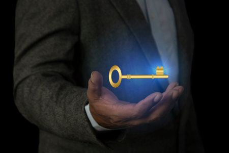 Businessman hand holding key icon on dark background.
