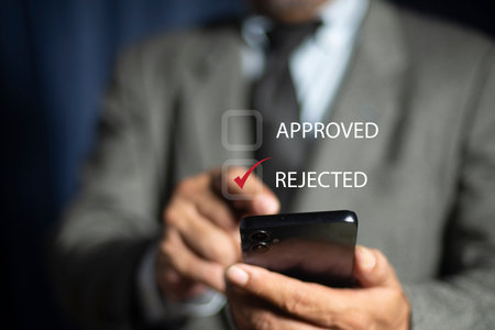 Businessman hand finger point and choose word Reject. check electronic documents on digital...