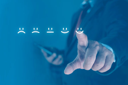 Businessman using smartphone pressing smiley face on touch screen. Business service satisfaction conceptの写真素材