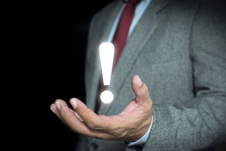 Businessman hand showing white exclamation mark, error warning, notification, maintenance, and finding a solution. business development conceptの写真素材
