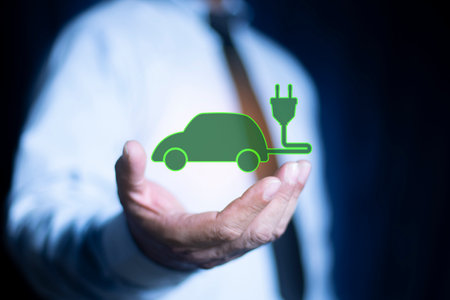 Business man hold Electric car with plug icon symbol, EV car, Green hybrid vehicles charging for...