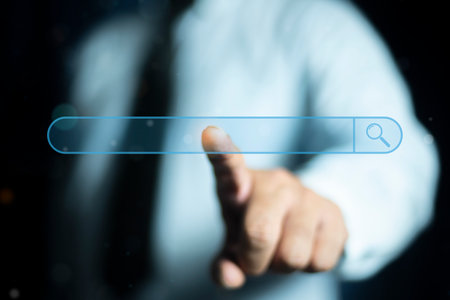 Person touching search bar on virtual screen. Search bar internet data browser. SEO search engine optimization concept. Marketing ranking traffic website, internet technology for business company.の写真素材