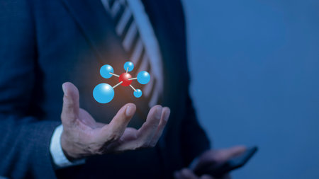 Businessman hand holding glowing atom molecule hologram. Nuclear fusion concept, Endless energy, Cheap electricity, Future technologies. Science, Power and Innovation conceptの写真素材