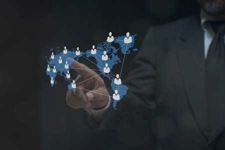 Businessman hand pointing global network connection world map people icons and line composition concept of global business.の写真素材