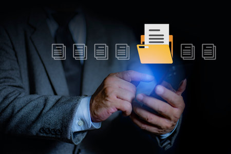Man uses a smart phone to search data on the server. Document Management System DMS, online document database. Searching, and management of company files and data.の写真素材