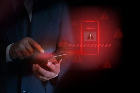 Digital Scam Warning on Mobile Phone Screen. Cyber threat warning with red alert, hacking, malware,...