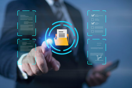 Businessman point at Yellow folder icon in center surrounded by various digital documents on virtual...