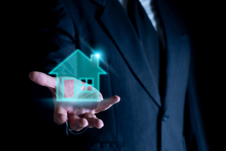 Businessman holding house icon, Real estate concept. House on Hand. Property insurance and security concept.の写真素材