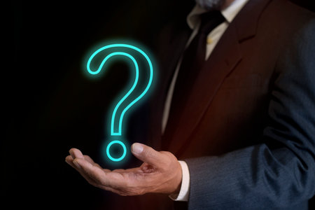 Businessman hand holding question mark. concept of ask, answer, Business FAQ, Thinking, and wondering. question tech Brainstorming and problem-solvingの写真素材