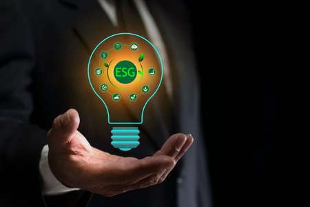 Businessmen holding a virtual light bulb globe with ESG icon. Social, Governance, net zero, carbon...