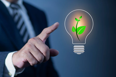 Businessmen pointing Light illustration with leaf for green electricity. Net zero carbon dioxide emissions by 2050. Climate change, global warming, greenhouse gases.の写真素材