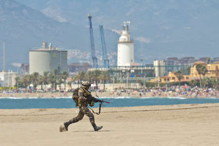 Malaga, Spain - May 28, 2011: Soldier running for cover in the Spanish Army Dayのeditorial素材
