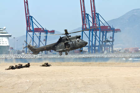Malaga, Spain - May 28, 2011: Eurocopter AS-532UL Cougar of the Spanish Navy landing on the beach in the Spanish Army Dayのeditorial素材