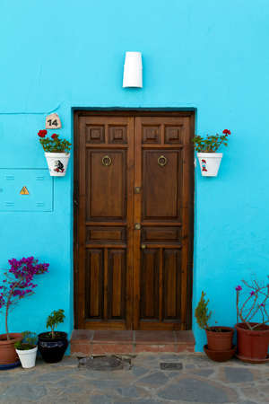 JUZCAR, SPAIN - CIRCA JUNE 2011: House door decorated with Smurfs pictures circa June 2011 in Malaga, Spain. The village was painted blue after Sony chose it for the world premiere of the new movie のeditorial素材